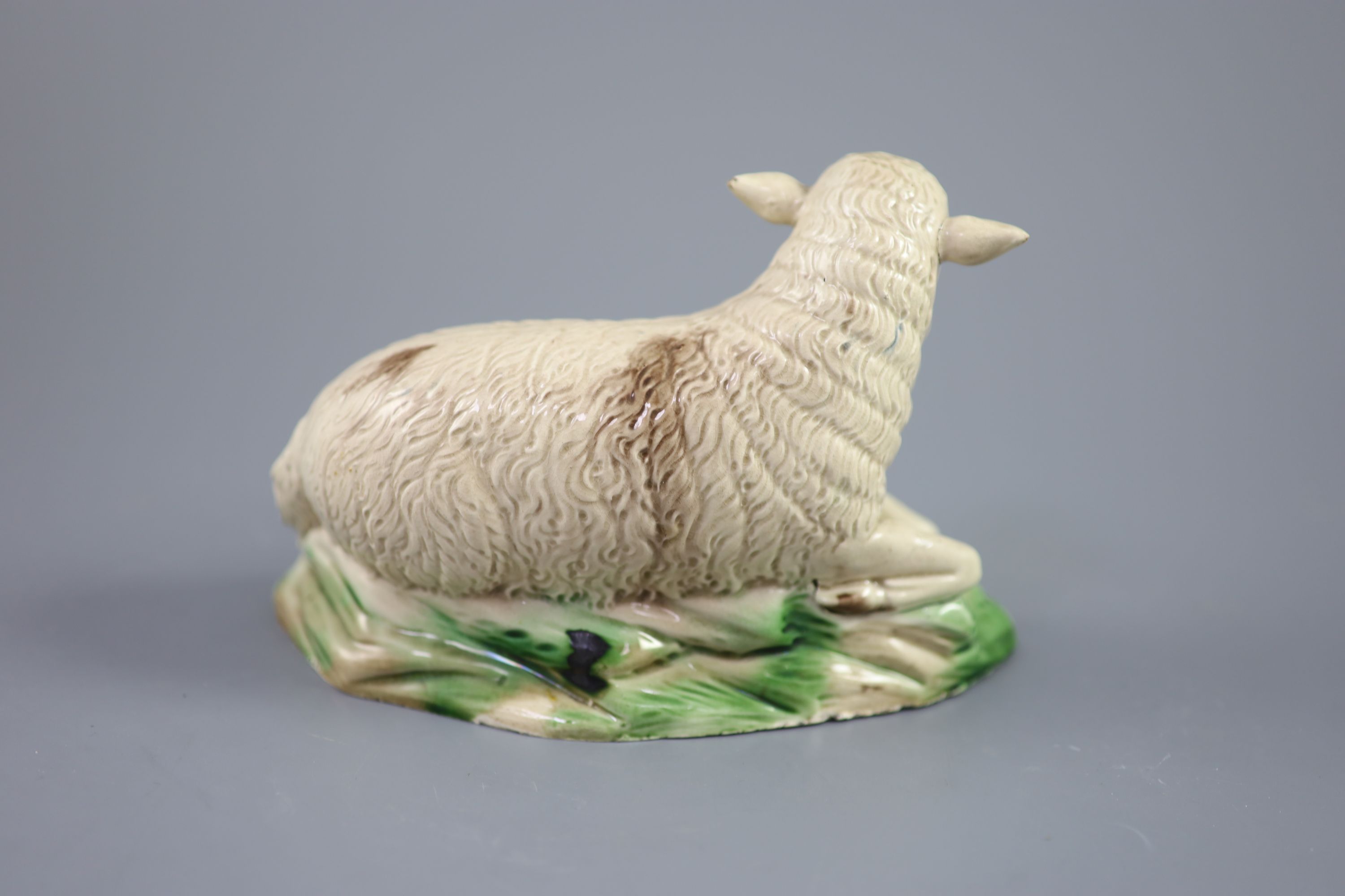 A Ralph Wood the Younger polychrome pottery figure of a recumbent ewe, c.1780-90 , length 18cm